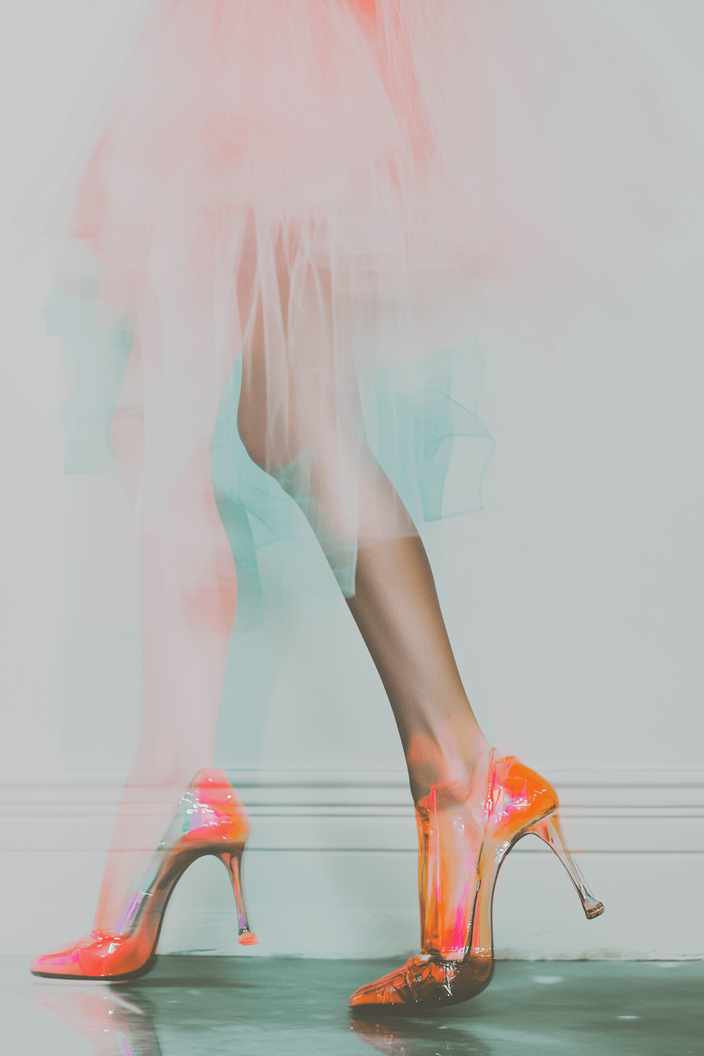 Glossy coral heels worn with a flowing pink tulle skirt